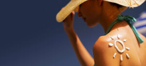 women tanning at the beach with sunscreen on